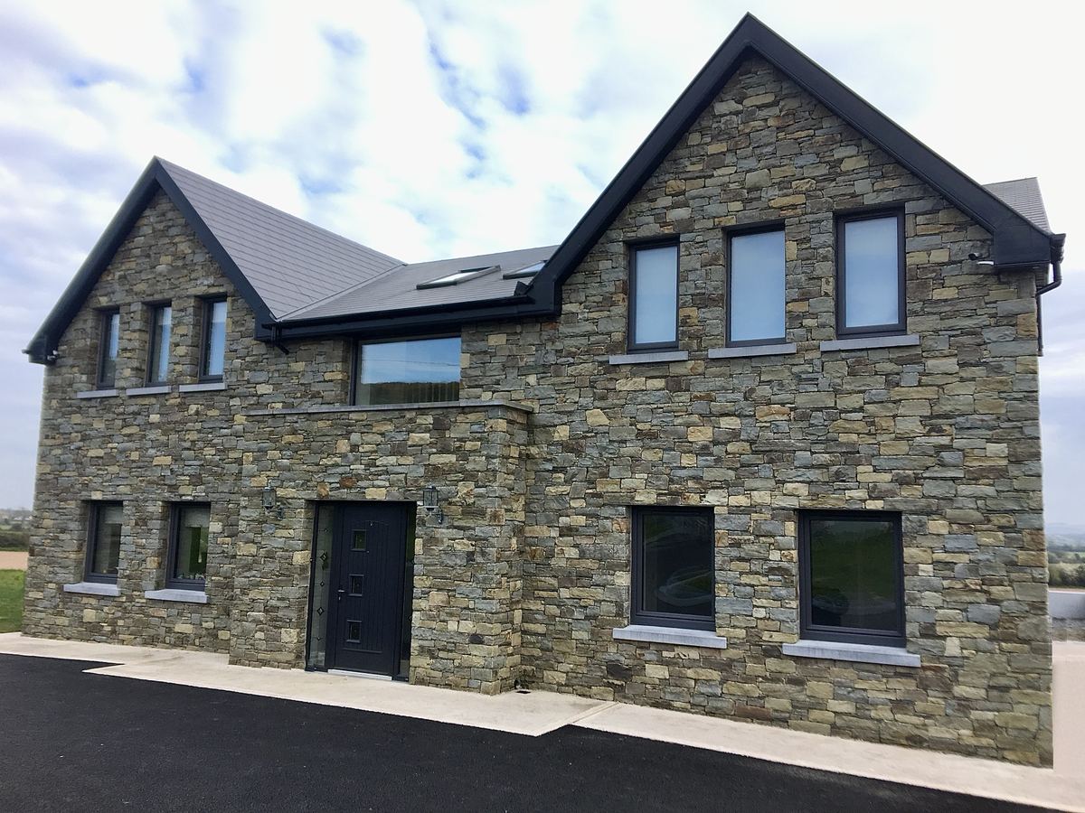 Two-storey house faced in natural stone by Natural Stone Masonry Ltd, Co. Cork