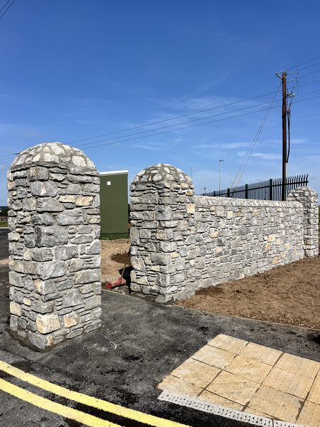 Stone entrance walls with domed pillar caps on the M28 Ringaskiddy motorway scheme, Co. Cork