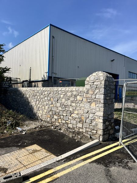 Random rubble limestone boundary wall with domed stone pillar, M28 Ringaskiddy scheme, Co. Cork